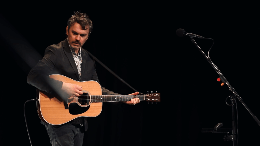 (Photo by Brian Connolly from a screen grab of the concert film)